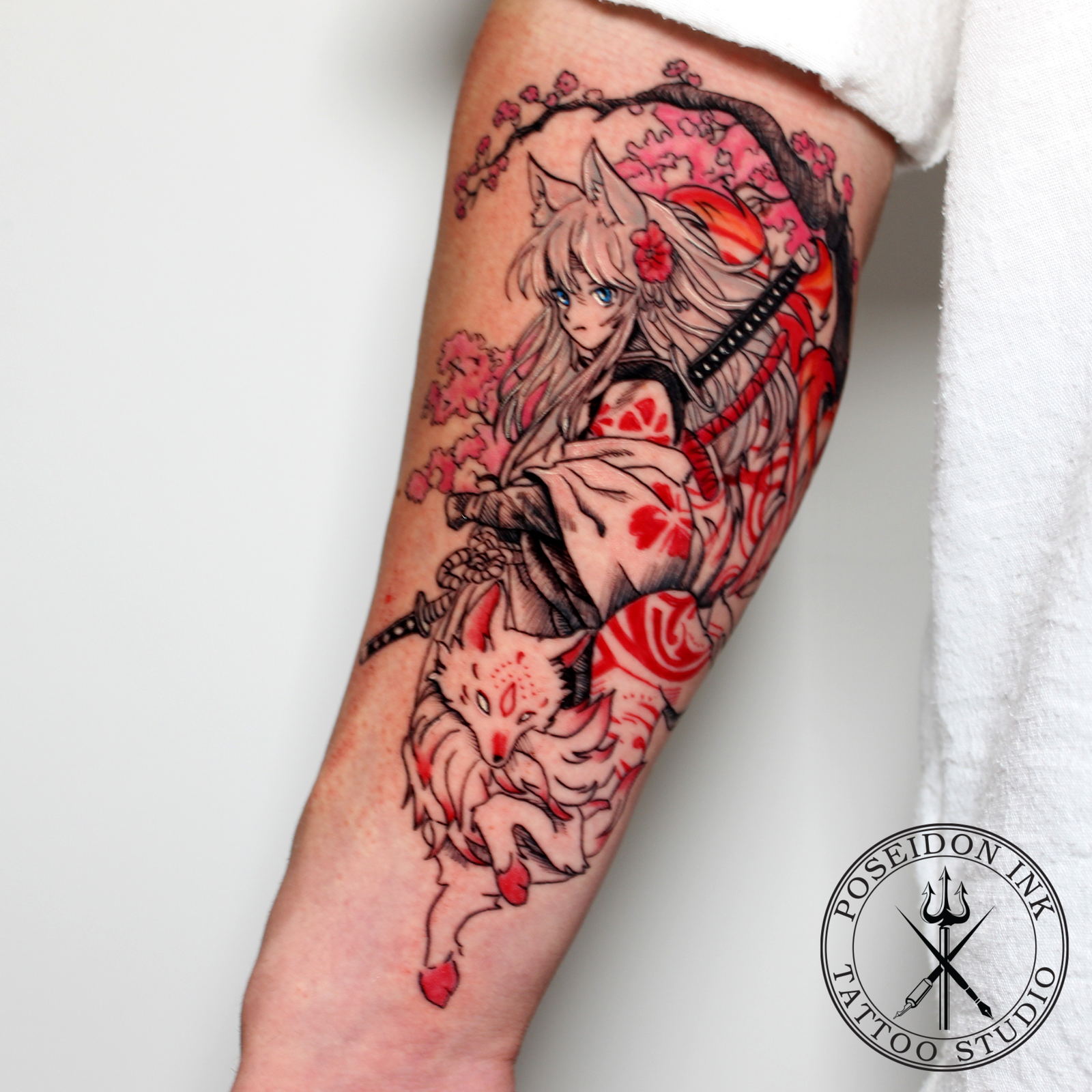 Colour anime style tattoo of a fox-eared girl with katana and a white kitsune fox beneath cherry blossoms, upper arm