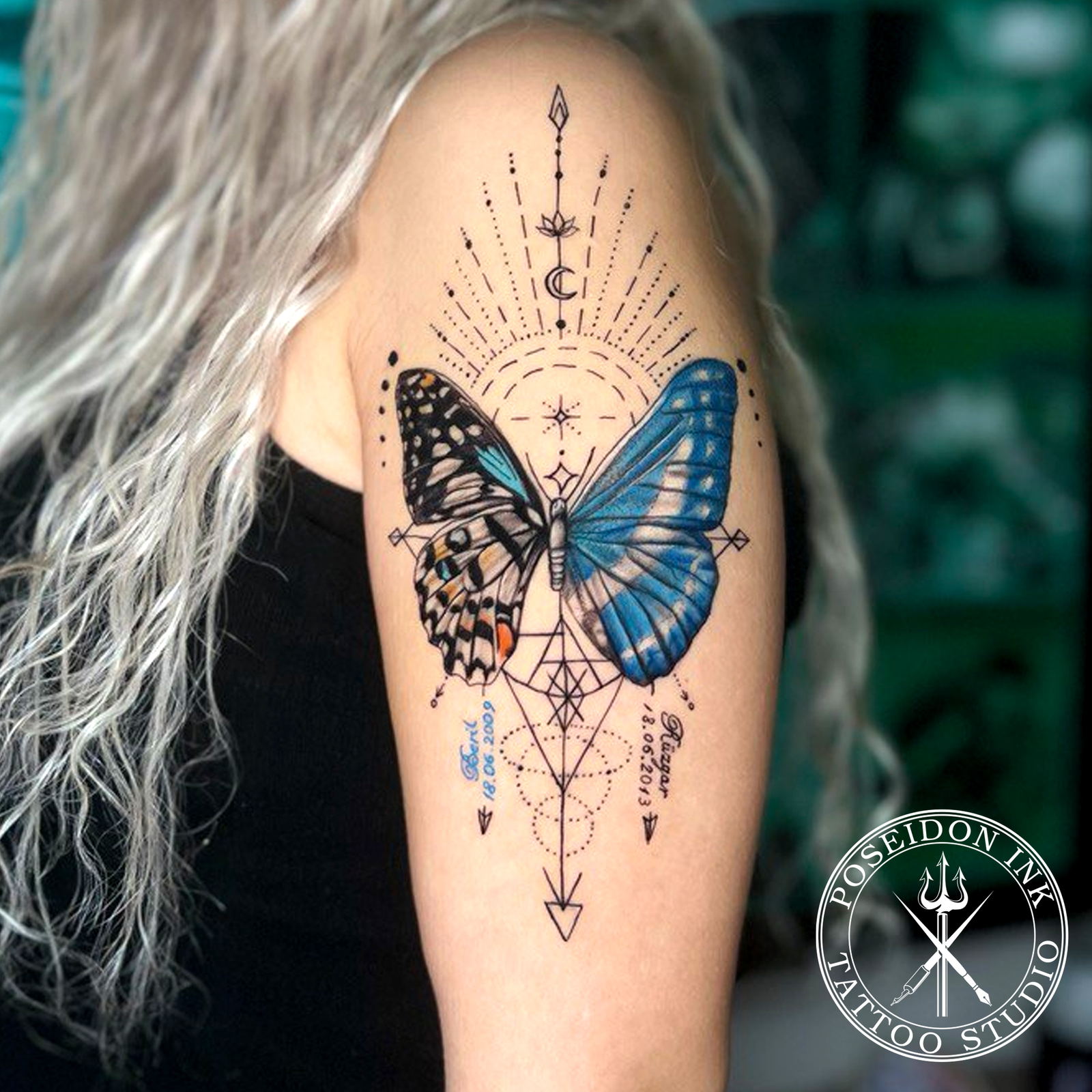 Tattoo of a butterfly with two different realistic wings over a geometric arrow, lotus and dotwork, with names and dates