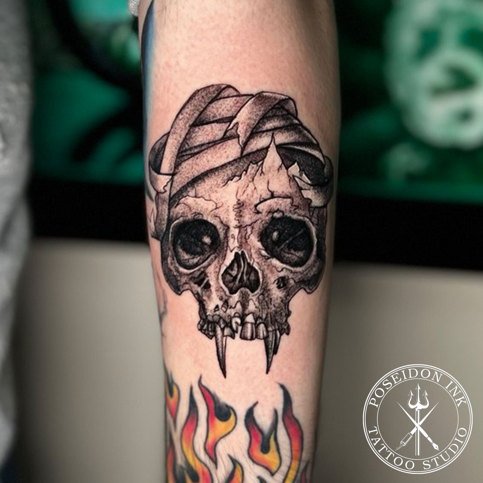 Etching style tattoo of a cracked skull with fangs wrapped in torn bandages, built from stipple shading