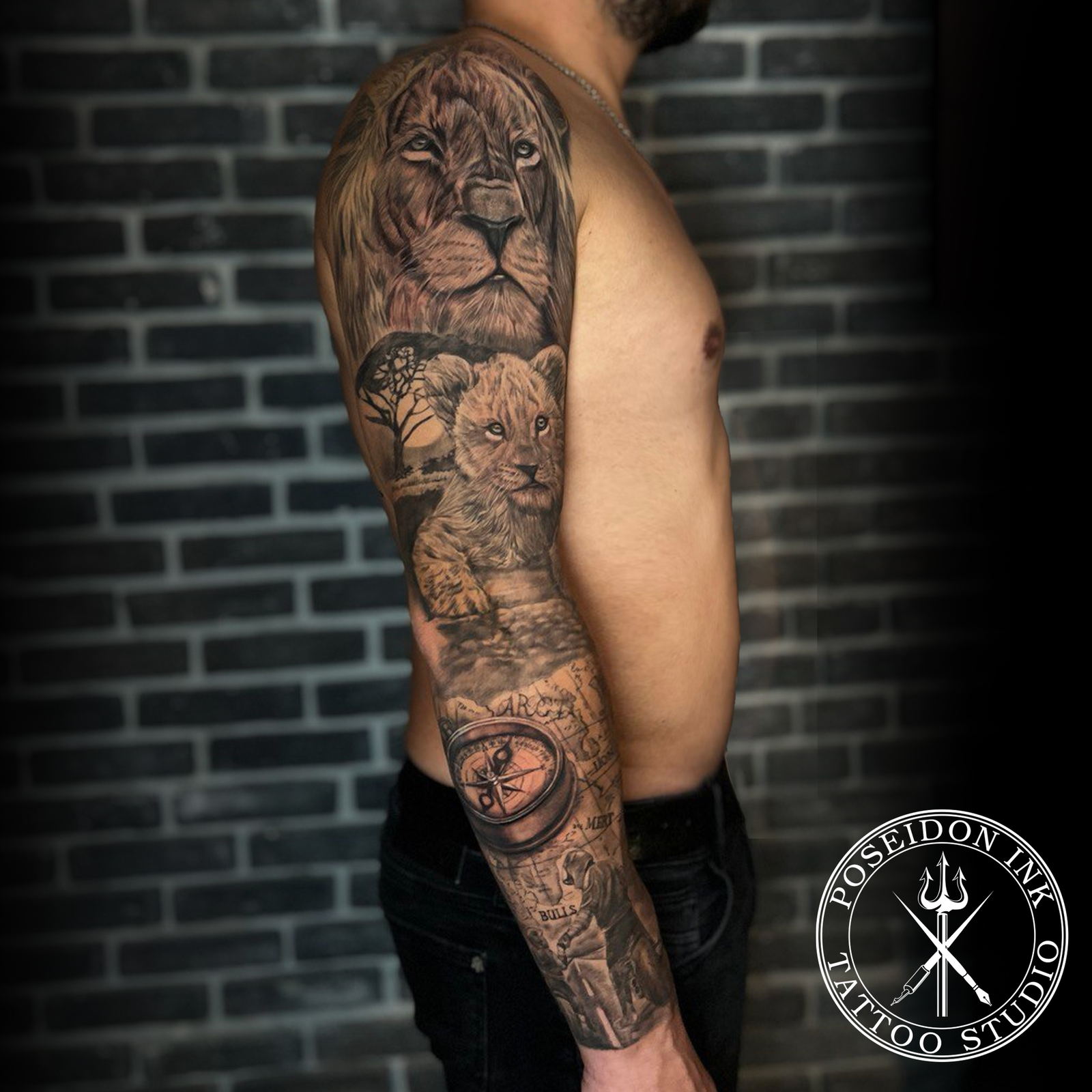 Full sleeve black and grey realism tattoo with lion portrait, cub, savanna tree, antique world map and brass compass